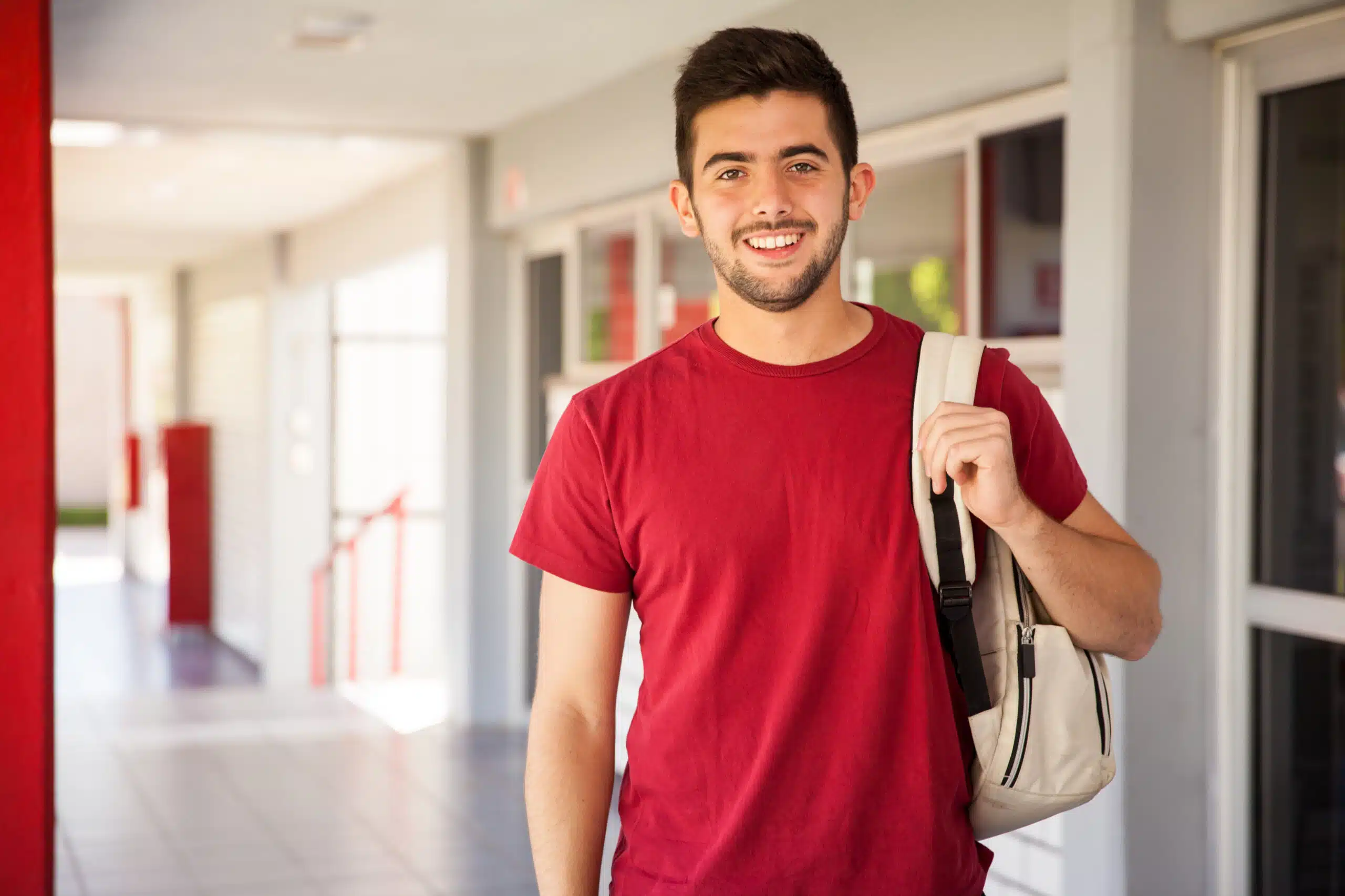 portrait hispanic college student carrying backpack standing school hallway scaled 2